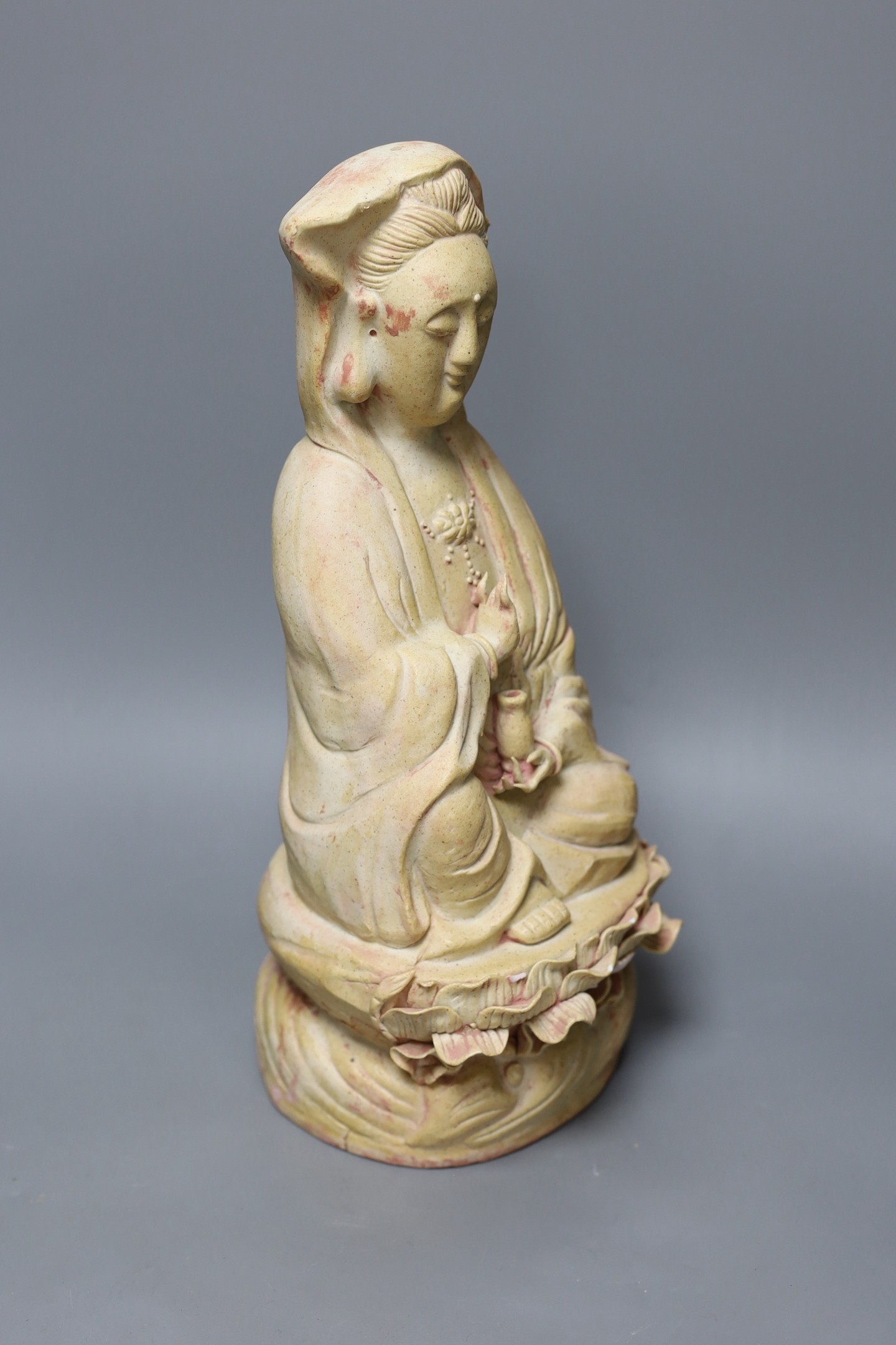 A Chinese biscuit figure of Guanyin, 38 cms high